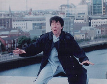 Jackie Chan in black coat on rooftop 8x10 inch photo