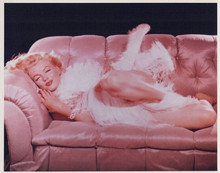 Marilyn Monroe vintage 8x10 inch photo stretches on sofa in boa feathers