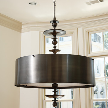 Global Views Turned Pendant Chandelier--Antique Bronze Finish--Small
Dimensions: 30"DIA x 50"H
*Oversized Item, White Glove Delivery, Crated
Holds six 60W candelabra bulbs
46" bronze chain, Clear silver cord
Round drum bronze finished steel shade
Bronze finish canopy