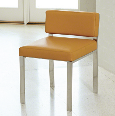 Camel colored and stainless steel armless and low-back chair