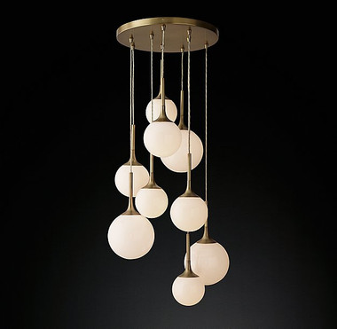 Whitney Chandelier
H: 58.5in Dia: 30in
Nine opal glass globes cascade in carefully staggered lengths from a large antique brass finished steel canopy, making an instant statement in a stairwell or double-height foyer.
MSRP: $ 3900.00