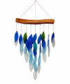 Waterfall wind chime presenting a cascade of hand cut, sandblasted, blue, green and gray ombre glass chimes suspended from a natural wood canopy
