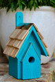 Brand new wooden bird house hand crafted with cypress wood construction featuring a copper trimmed and shingled roof with each shingle hand cut and stone washed.  Hand painted in rich teal finish with light distressing.