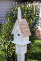 Brand new bird house designed to recall a small village church.  Hand crafted of sturdy PVC and cypress wood construction, topped with a hand-shingled roof accented with a copper peak.