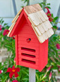 Brand new neon red ladybug house hand crafted of solid wood with a shingled roof accented with a metal peak that will age and weather beautifully through the years.  The facade features three horizontal entryways/exits and a decorative ladybug applique.