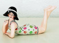 Small nostalgic bathing beauty figurine clad in a multicolor floral swimsuit and black sun hat.  Molded of resin and beautifully hand painted.