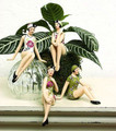 Nostalgic quartet of miniature bathing beauty figurines clad in tropical floral swimsuits and coordinating swim caps.  Molded of resin and beautifully hand painted.