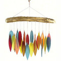 Wind chime showcasing colorful hand cut, sandblasted glass chimes suspended from a natural driftwood canopy.  
