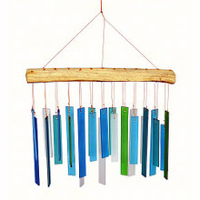 Wind chime presenting colorful blue, gray and green hand cut, sandblasted glass chimes suspended from a natural driftwood canopy.
