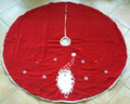 christmas tree skirt with hand sewn santa face design set against a red velvet background with a decorative white border trim.  full design shown in this photograph.