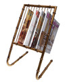 Free-standing bamboo style magazine rack cast of iron with an antiqued gold finish.