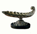 Footed centerpiece featuring a feather shaped scoop with an ornate base.  Cast of solid brass with an antique brass patina presented atop a black marble stand.  