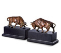 Double bull bookends intricately cast of brass with a rich flamed patina finish mounted atop black wood bases