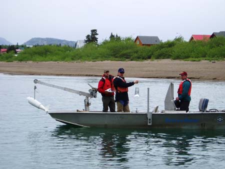 U.S. Geological Survey D-96 sampler being deployed from boat.