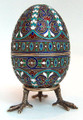 The egg opens at the center and is marked with the silver quality mark "84" on the interior of both halves along with a right facing kokoshnik and the delta symbol for the city of Moscow. The initials "AAT"  in Latin letters also appear on each half of the egg. These are the maker's marks for an unknown Russian silversmith. The stand  has the silver quality mark "84". This piece is in excellent condition overall with no noted loss of enamel.