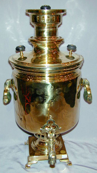 An antique Russian brass samovar featuring a classical s…