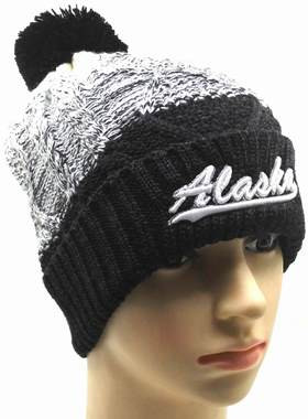 black hat with cream pom pom