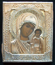The riza is marked with a silver mark  "84"  a maker's  mark (P.T.) and a right facing kokoshnik with triangle. The lower edge of the riza also has a full maker's mark for the V.S. Krestyaninov Factory, Moscow. The painting has been touched up in two places on the Madonna's face and there is some minor chipping of the paint where the riza has rubbed against the panel. The wood panel is covered at the back with faded red velvet.