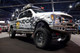 Lower Front Side View of The 2017-2022 Ford F250/350 S.D. 4wd 6" MaxTrac Forged Four Link Lift Kit W/ FOX Shocks - K883362F-4L