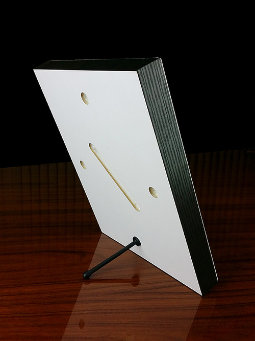The back of the 8x10 panel showing the included stand and pre-drilled mounting holes.