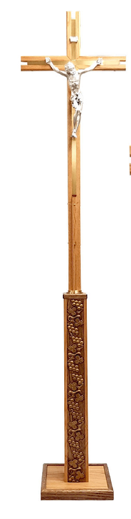 Use this beautiful cross for the procession at the beginning of the Mass and then place it in a carved wood stand.  The cross features a 12" Corpus with a high polish silver finish.  It is inlaid with brass panels with a satin finish.  The stand is also made of wood with a lovely grape and leaf relief pattern with gold metallic accents.  The overall height of this processional Crucifix is 77" and the square base measures 12".   MADE IN THE USA!