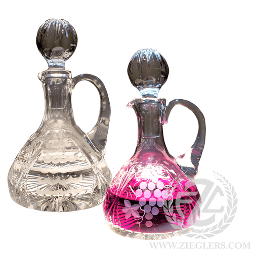 This pair of glass cruets comes with a pinwheel design. The water cruet capacity is 5 OZ and wine is 7.5 OZ. and come with glass stoppers to help keep the contents sealed. 
Details:
Water Cruet:
5 OZ Capacity
6" Height (w/stopper)
Wine Cruet:
7.5" Capacity
6" Height (w/stopper)
Sold as a pair
From Poland