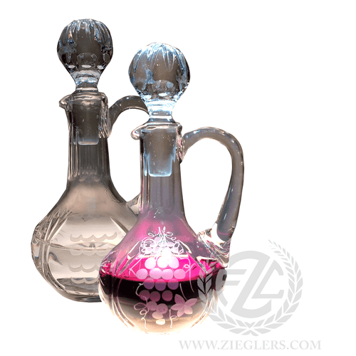 This pair of glass cruets comes with a sandblast design. The water and wine cruet capacity is 5.5 OZ and come with glass stoppers to help keep the contents sealed. 

Cruet Details:
Glass
Sandblast Design
Stopper Top
Cruets:
 5.50 OZ Capacity
7.5" Height (w/stopper)
Sold as a pair
From Poland