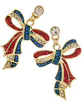 The patriotic ribbon bow earrings are exceptional and attractive. The striped ribbon is embedded with red, white and blue crystals and is in the shape of a tied bow and have a large crystal at the top of the drop. Gold plate, drop approx. 1.3" and has post back.