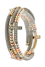 Predominantly silver coil bracelet with 3 side crosses encrusted with diamond-like crystals surrounded by bronze, gold and silver beads.